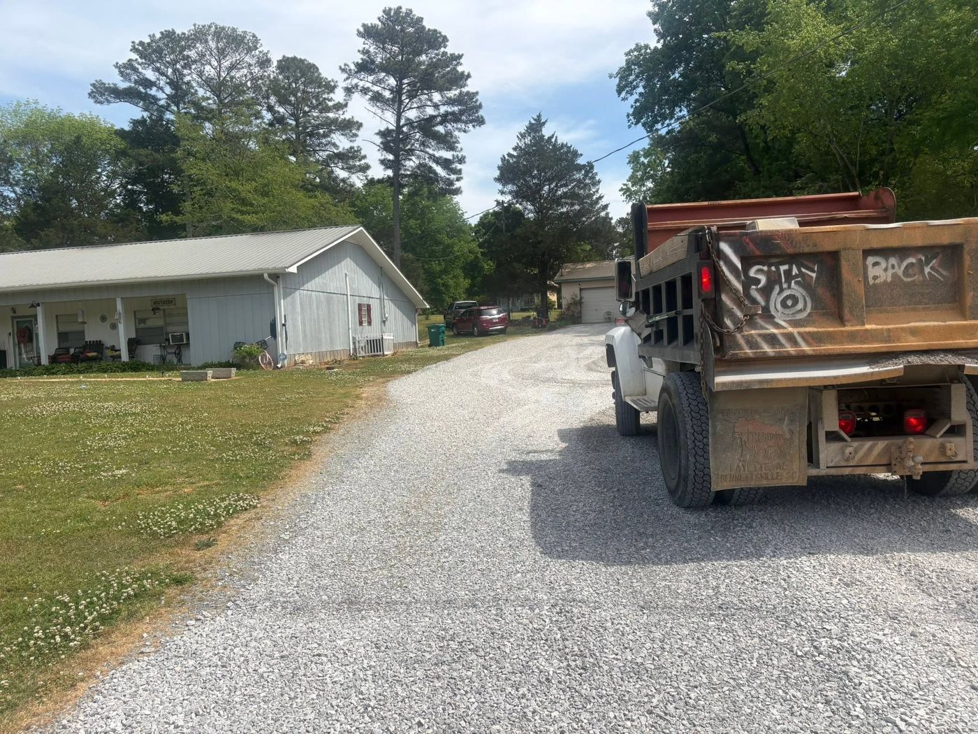 Dump truck on a freshly spread gravel driveway